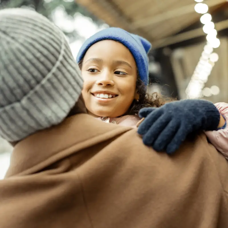 Feeling cheerful. Beautiful curly dark-haired daughter feeling cheerful spending time with father